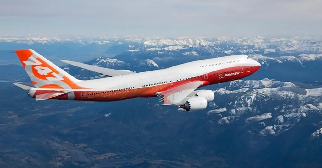 This breathtaking image captures the might of the Boeing B747-800F freighter as it glides over a majestic mountain.