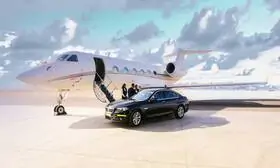 Legacy 600 private jet sits majestically on the airport apron, its gleaming exterior contrasting against the backdrop of billowing clouds and shimmering sea.