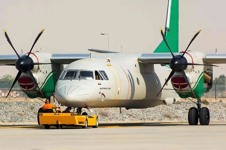 Antonov an132 on the apron and there is puch back car