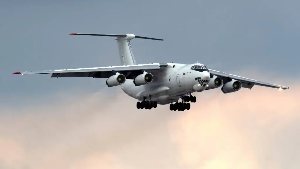 Imagine a majestic ILYUSHIN IL-76 soaring high in the sky, cutting through the ominous clouds like a sword through silk