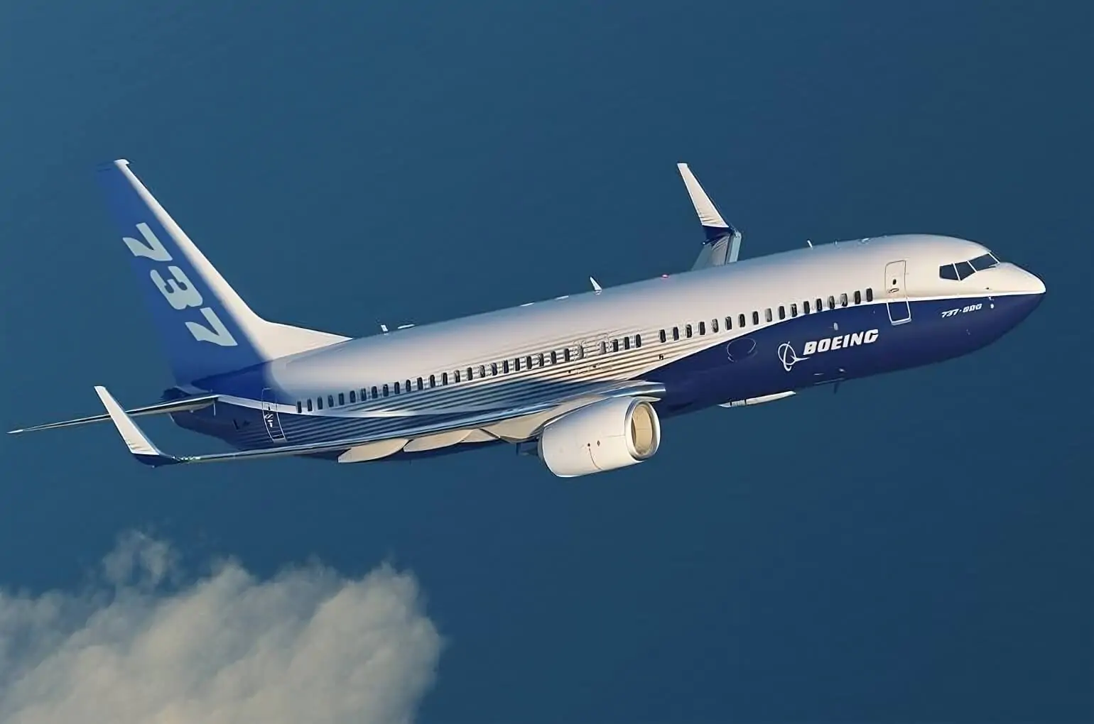 "This captivating image captures a Boeing 737-800 soaring gracefully high in the sky, surrounded by billowing clouds.