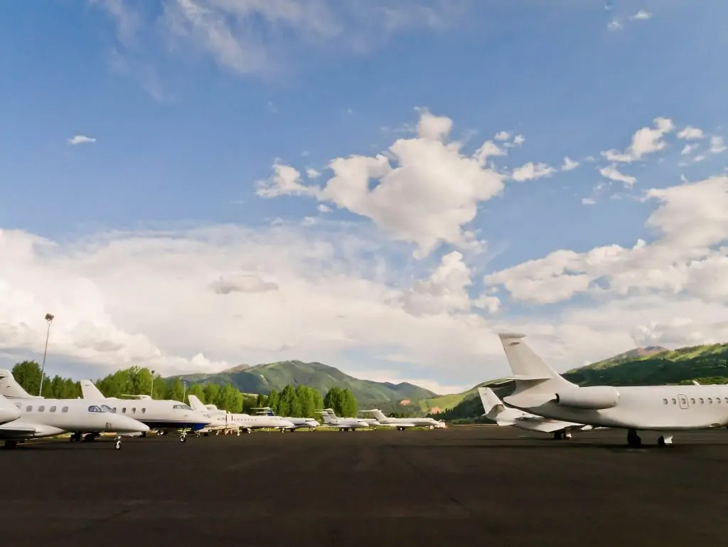 Sky N Jet's diverse fleet of private jets gathers in the airport, framed by the lush green backdrop of nature